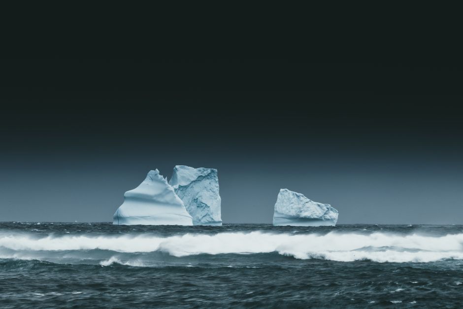 An iceberg with most of its mass hidden underwater, the classic metaphor for the hidden dark web beneath the surface web