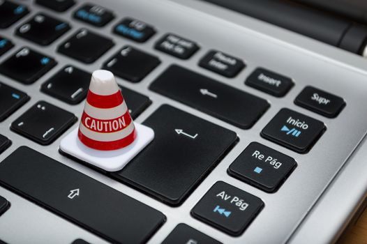 A caution cone on a keyboard representing a marketplace phishing warning