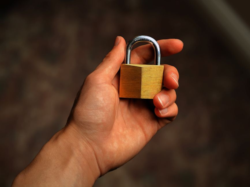 A hand holding a padlock symbolizing verifying a marketplace link before trusting it