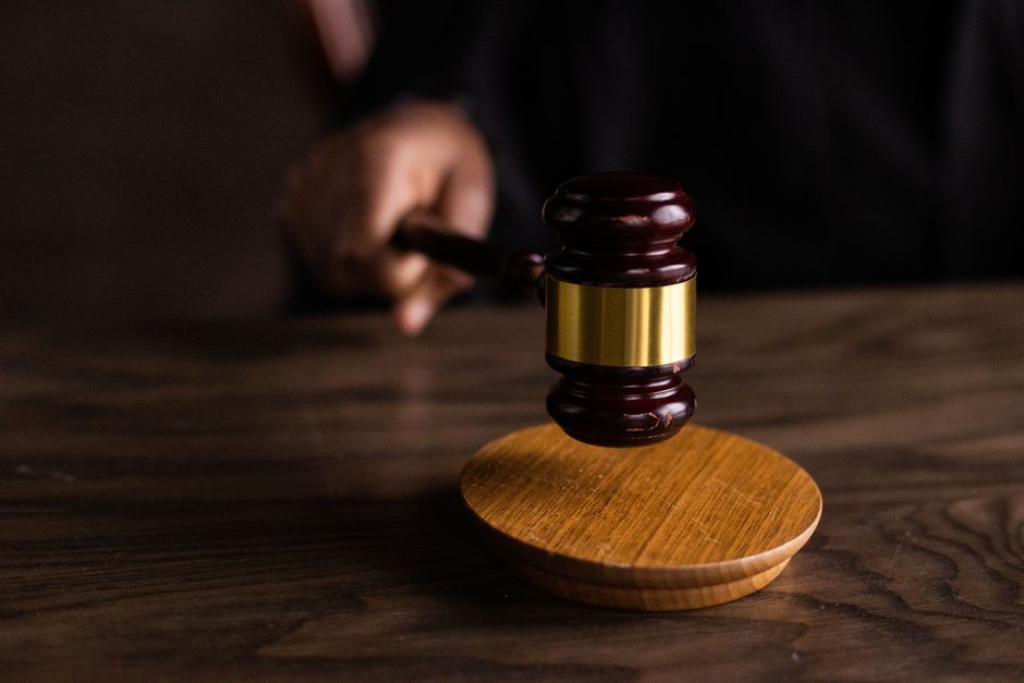 A judge's gavel striking a sound block, symbolizing legal authority over internet activity