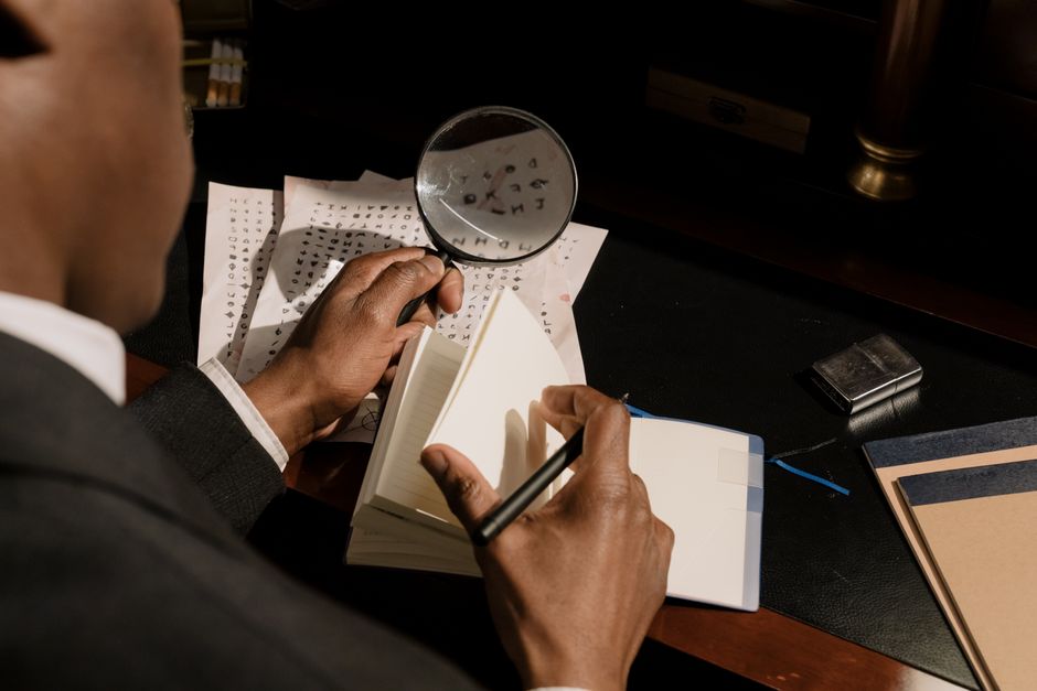A magnifying glass over encrypted documents in moody light, evoking searching Tor hidden services