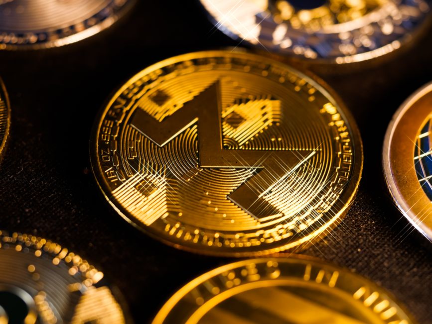 Gold Monero coin closeup focusing on digital currency privacy and blockchain forensics
