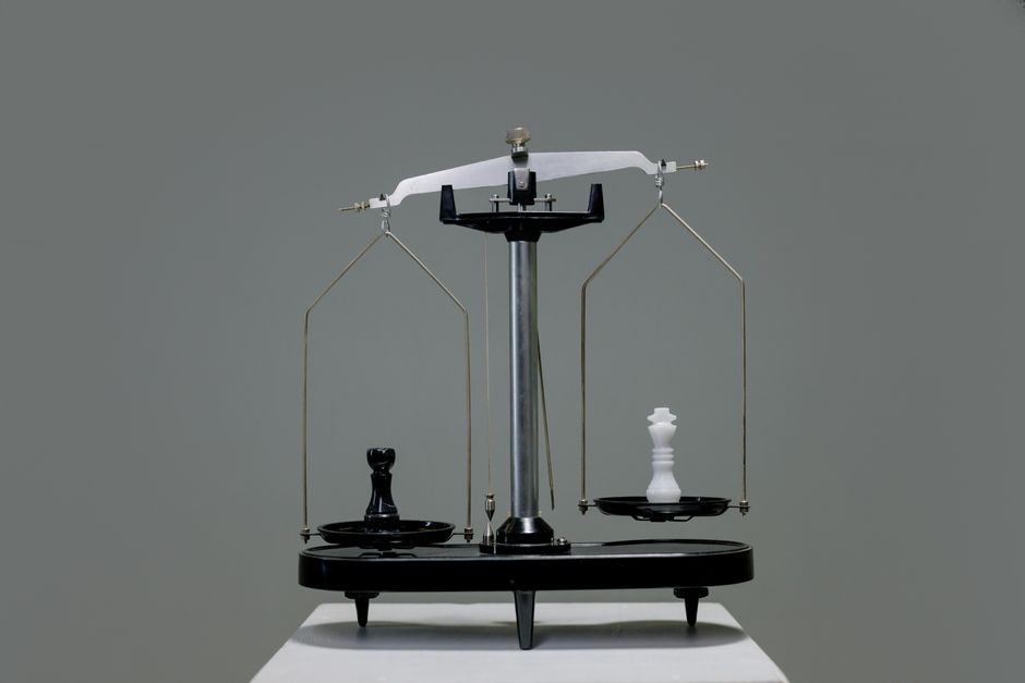 Chess pieces balanced on a scale representing a directory comparison